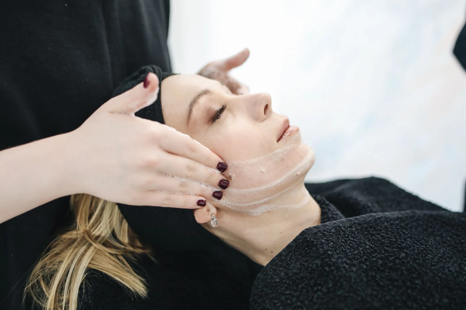 Client receiving a facial treatment at a beauty clinic