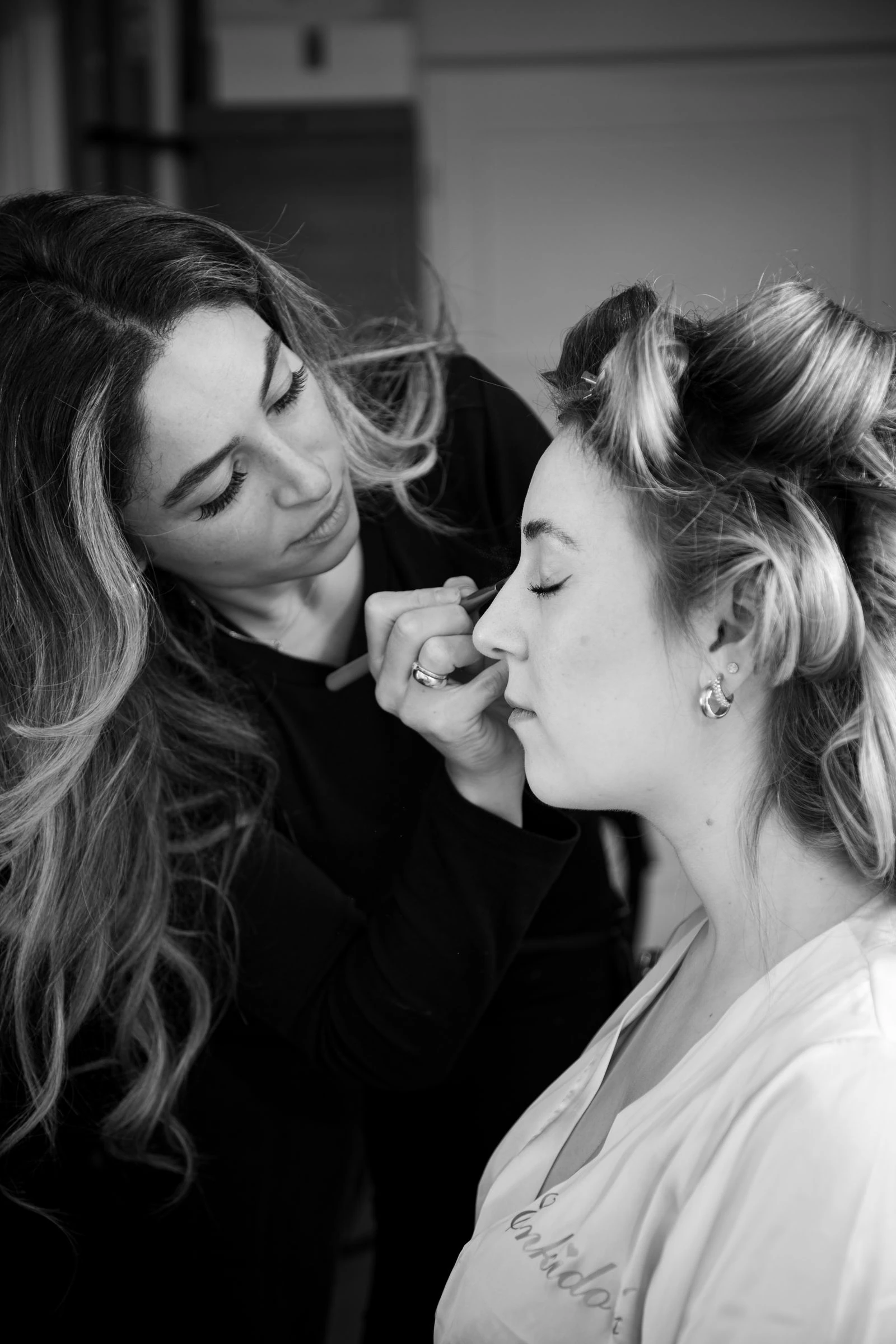 Makeup artist preparing a bride before her wedding